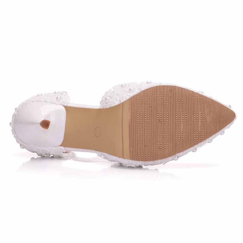 bridal closed toe high heel sandals with a decorative beaded design and a clear heel