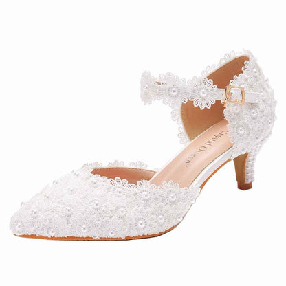 Elegant white bridal sandals with low heel featuring lace and floral details for a comfortable bridal look