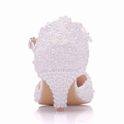 White bridal sandals with lace detailing and pearls, perfect for comfort with a low heel