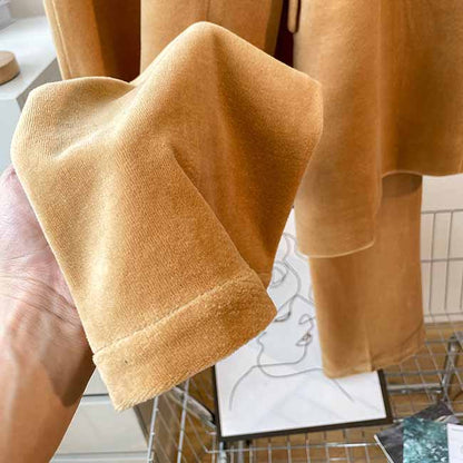 Close-up of camel velvet women's pantsuit fabric showcasing soft texture and rich color