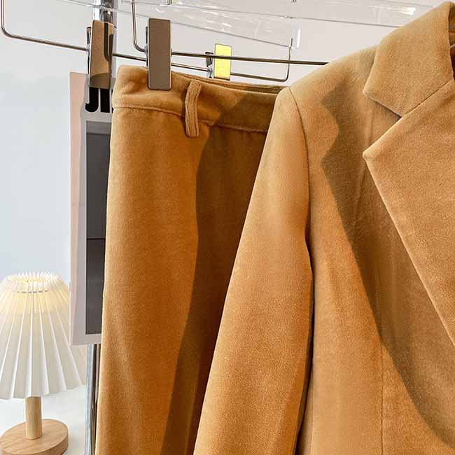 Camel velvet women's pantsuit featuring a tailored blazer and matching trousers for a chic look