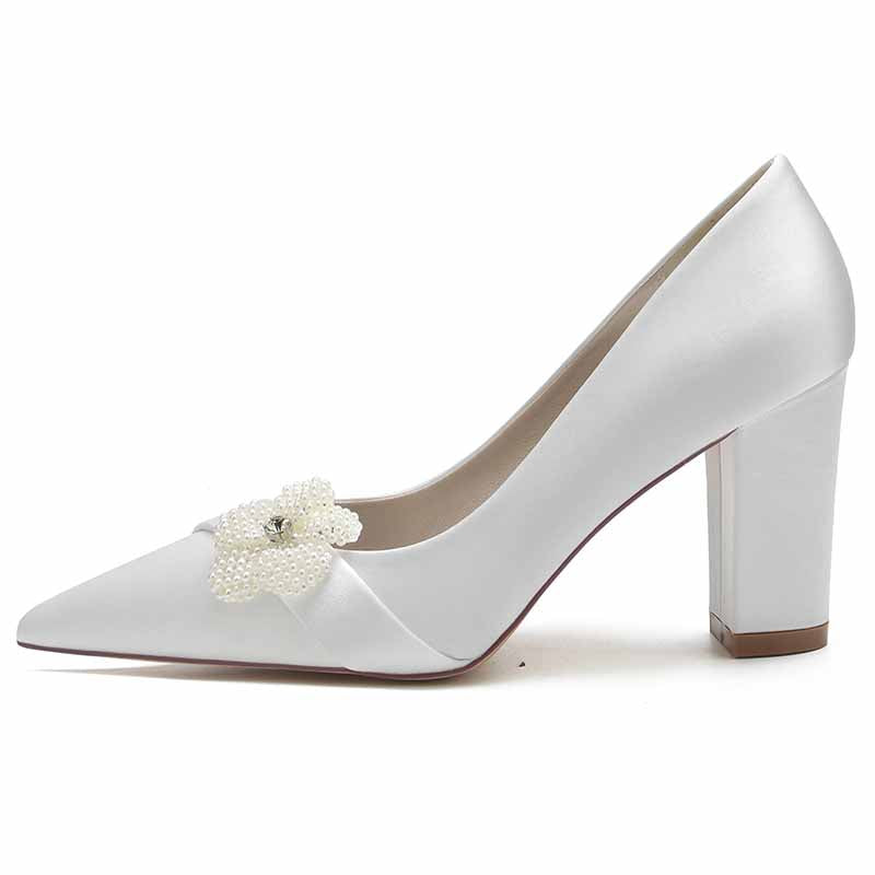 Elegant white chunky heel bridal pumps with decorative flower embellishment for a stylish wedding look