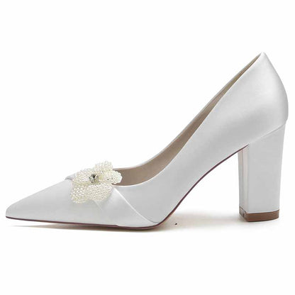 Elegant white chunky heel bridal pumps with decorative flower embellishment for a stylish wedding look