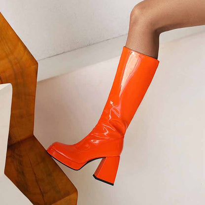 Bold orange women's knee high boots with chunky heel, perfect for stylish fall outfits