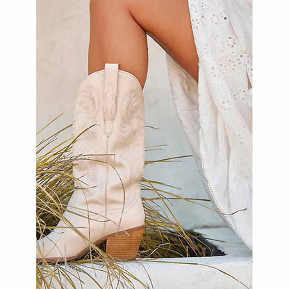 Embroidered cowgirl boots wedding in cream color paired with a flowing white dress for a stylish look