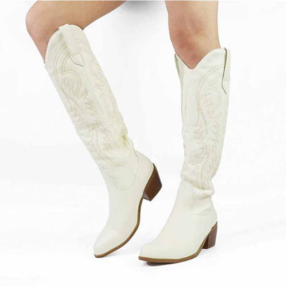 White embroidered square heel cowboy boots featuring detailed stitching and a stylish tall design