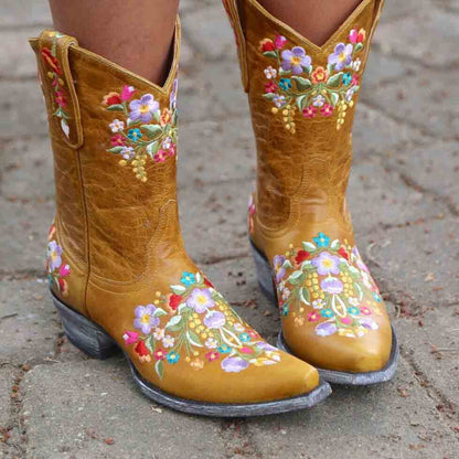 Embroidered western ankle boots for women in yellow with colorful floral design and a pointed toe