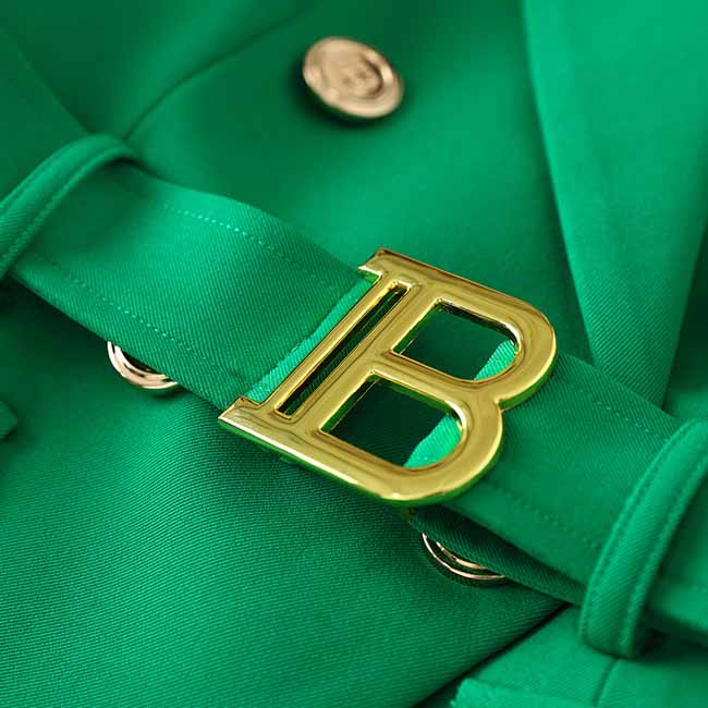 Emerald green blazer for women with gold buckle detail on the belt