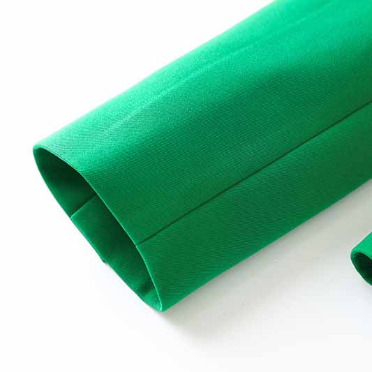 Emerald green blazer for women with sleek fabric detail showcasing its vibrant color
