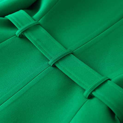 Close-up detail of an emerald green blazer for women featuring stylish stitching and fabric texture