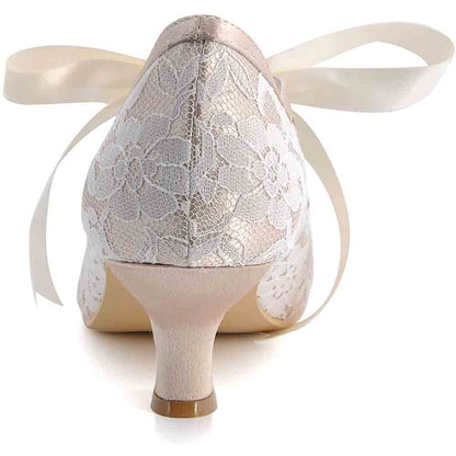Elegant lace wedding shoes for bride with delicate floral design and satin ribbon ties