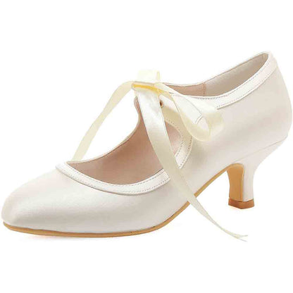 Elegant lace wedding shoes for bride with a delicate ribbon tie and stylish heel