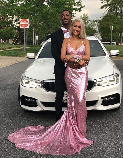 Elegant mermaid sequin prom dress in pink worn at a photoshoot with a couple by a car