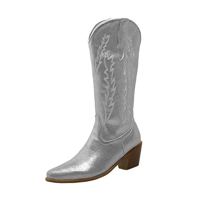 Shiny silver metallic cowgirl boots for women with stylish stitching design and a comfortable heel
