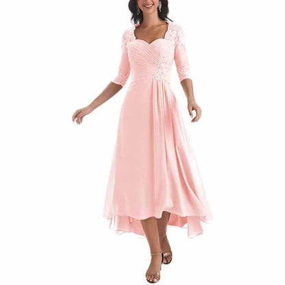 Elegant mother of the bride tea length dress in soft pink with lace sleeves and a flowing skirt
