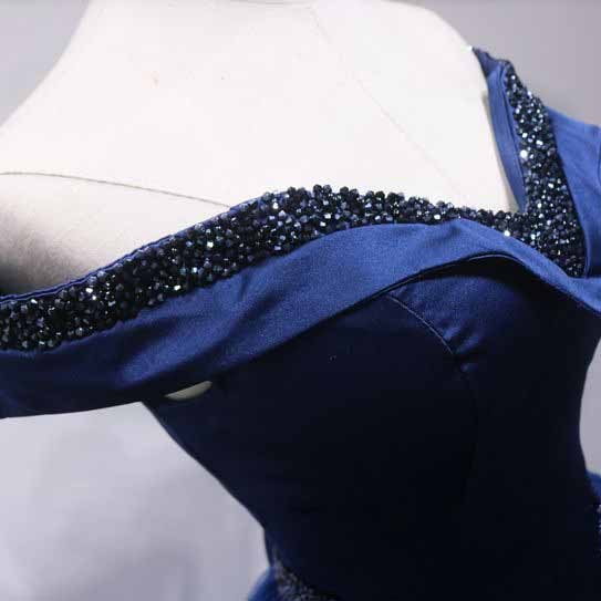 Close-up of off the shoulder ball gown prom dress featuring embellished neckline and elegant design