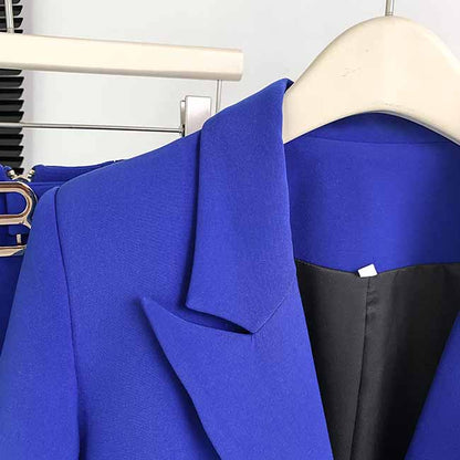 Close-up of a vibrant blue one-button bell-bottom suit for women showcasing the tailored lapel and pocket design