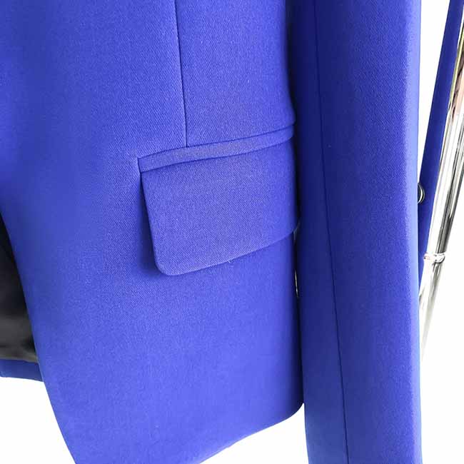 Close-up of a vibrant blue one-button bell-bottom suit for women featuring a stylish pocket