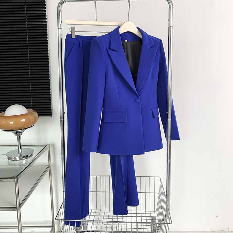 Stylish one-button bell-bottom suit for women in vibrant blue color hanging on a display rack