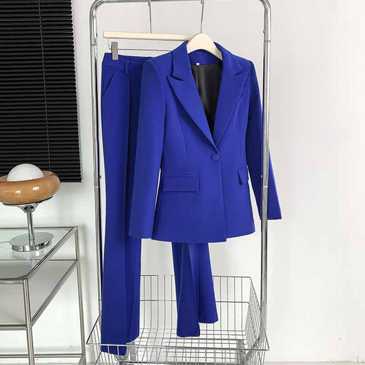 Stylish one-button bell-bottom suit for women in vibrant blue color hanging on a display rack