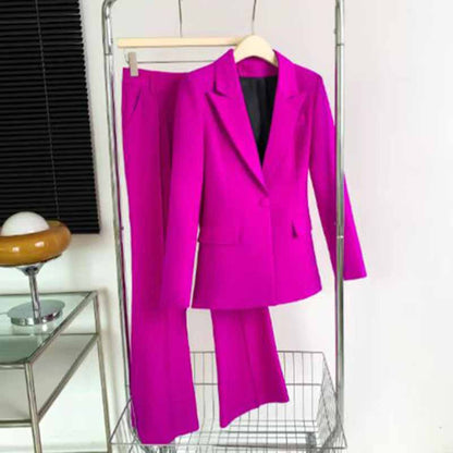 Vibrant pink one-button bell-bottom suit for women displayed on a clothing rack
