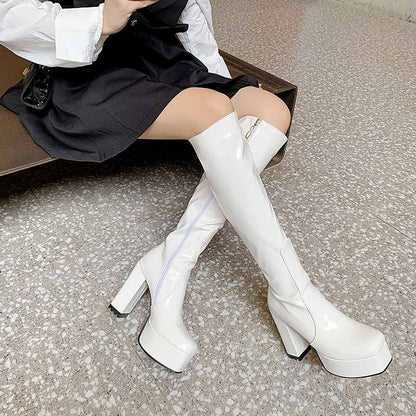 Stylish white platform high heel boots for women with a sleek design and chunky heels