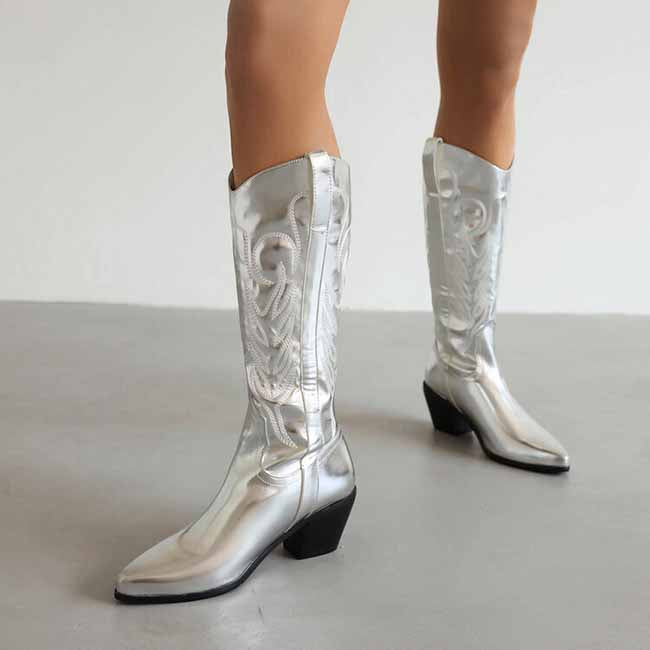 Shiny silver pointed toe western knee high boots with decorative stitching and a stylish heel