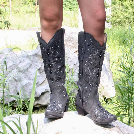 Black rugged rustic bridal cowgirl boots featuring intricate embellishments and a classic western design