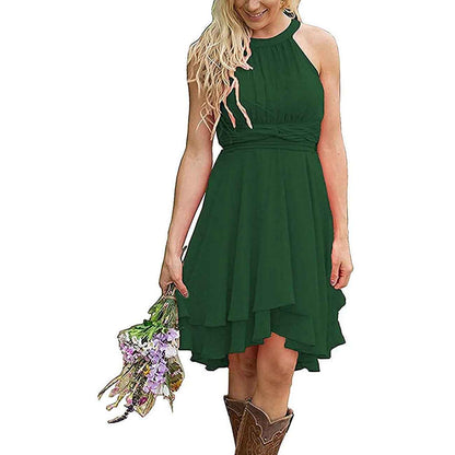 Green cowgirl bridesmaid dress for rustic wedding with a flowy design and floral bouquet