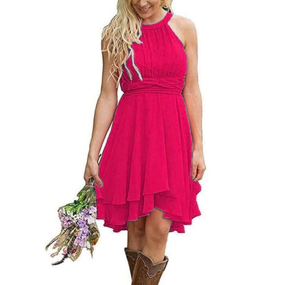 Pink halter cowgirl bridesmaid dress for rustic wedding with flowy skirt and cowboy boots