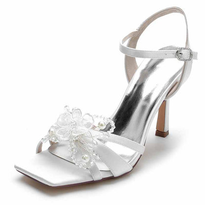 Elegant white satin pump heel sandal for bridesmaids featuring floral embellishments and ankle strap