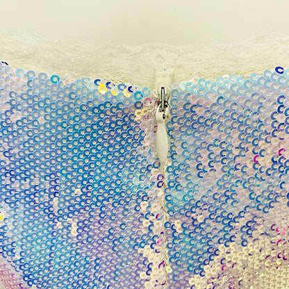 Close-up of a sparkly blazer and shorts set featuring colorful sequins and a stylish zipper detail