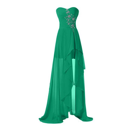 Green strapless bridesmaid dress long with a flowing design and decorative jewels on the bodice