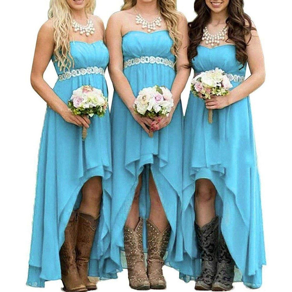 Three bridesmaids in strapless country wedding dress styled in blue with floral accents and cowboy boots