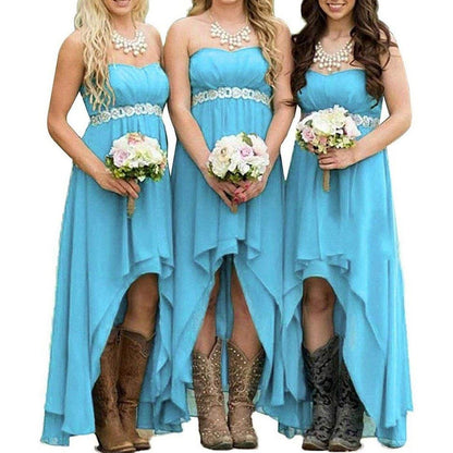 Three bridesmaids in strapless country wedding dress styled in blue with floral accents and cowboy boots