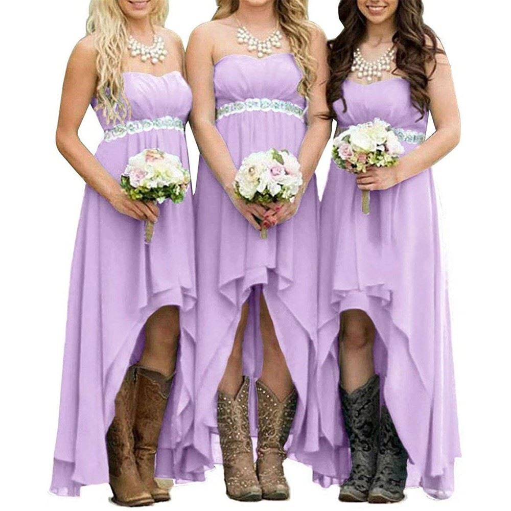 Three bridesmaids in lavender strapless country wedding dress with floral arrangements and cowboy boots