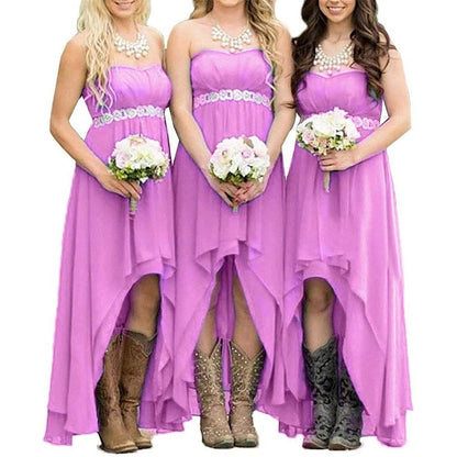 Three bridesmaids in strapless country wedding dress with floral accents and cowboy boots