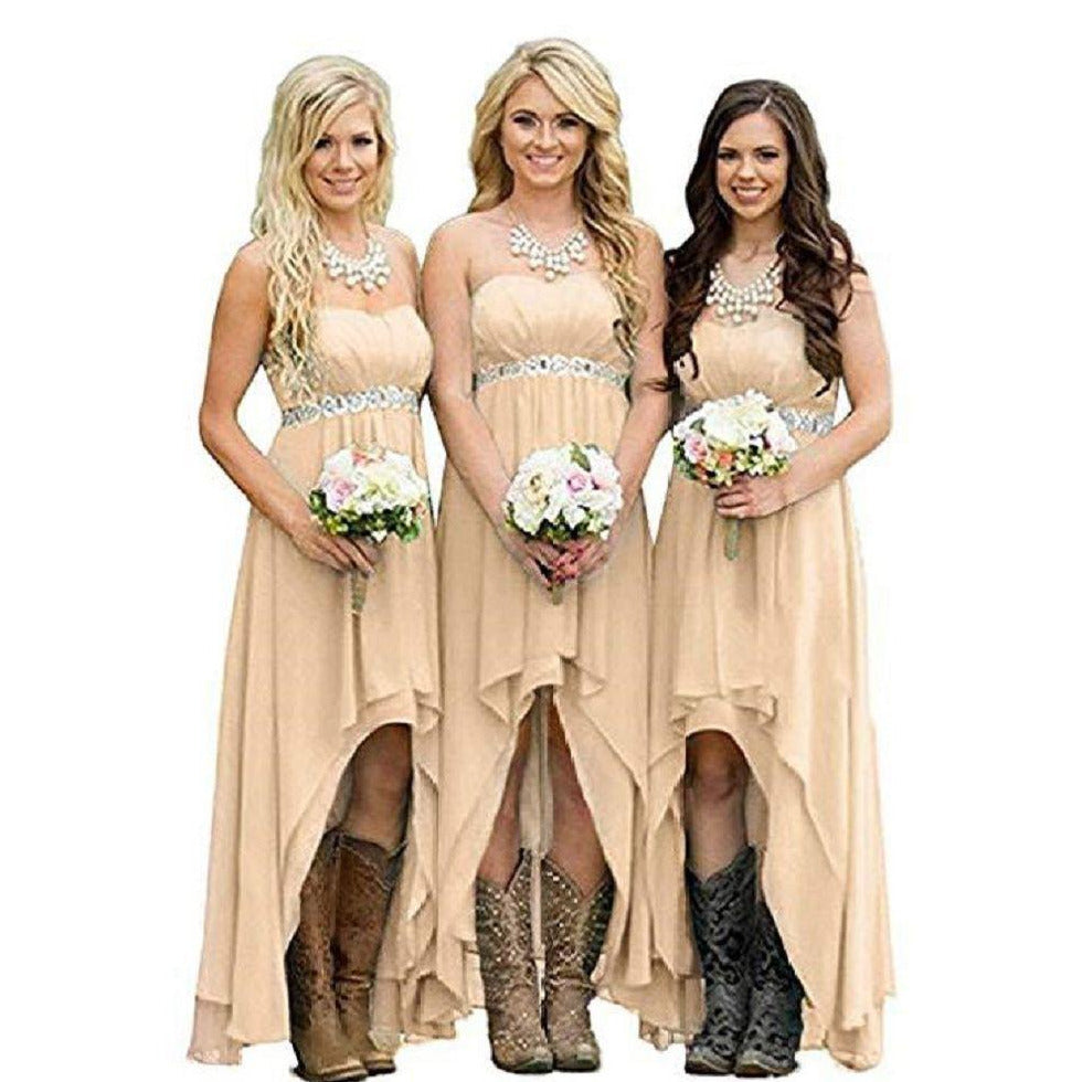 Three bridesmaids in strapless country wedding dress holding bouquets with cowboy boots