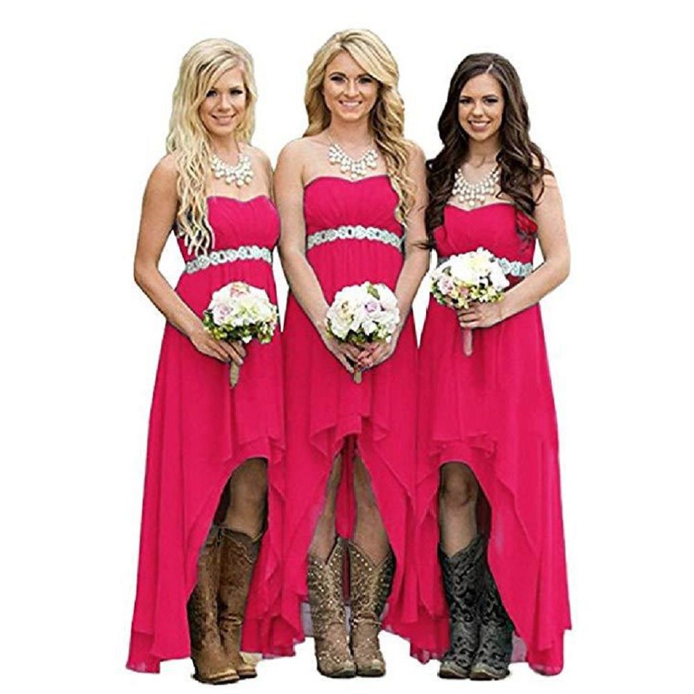 Three women in pink strapless country wedding dresses with floral bouquets and cowboy boots