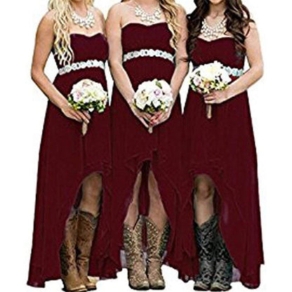 Three women in burgundy strapless country wedding dress with high slits and floral bouquets