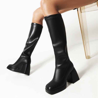 Stylish black knee high boots with chunky heels, perfect for fashionable outfits and comfortable wear