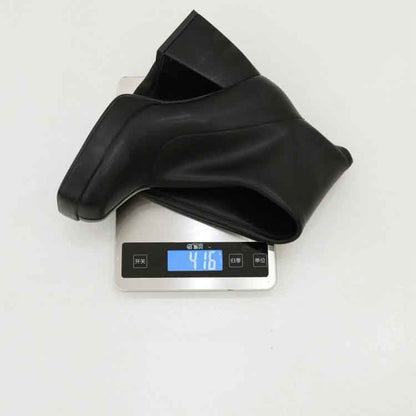 Stylish black knee high boots displayed on a digital scale showing their weight