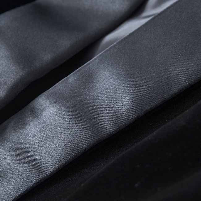 Close-up of a luxurious velvet wedding blazer neckline with smooth satin detailing