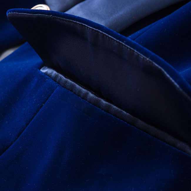 Close-up of a luxurious navy velvet wedding blazer featuring a detailed lapel and pocket design