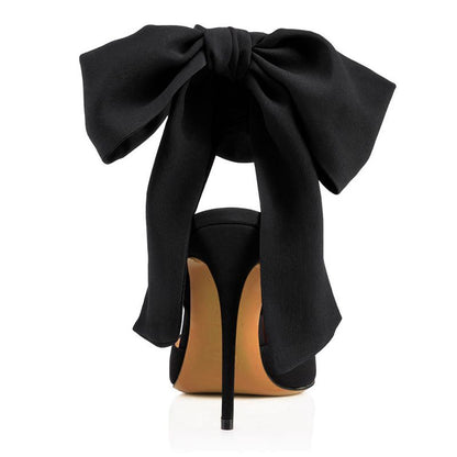 Elegant black heels featuring a large bow design, perfect for pairing with red satin bow high heels