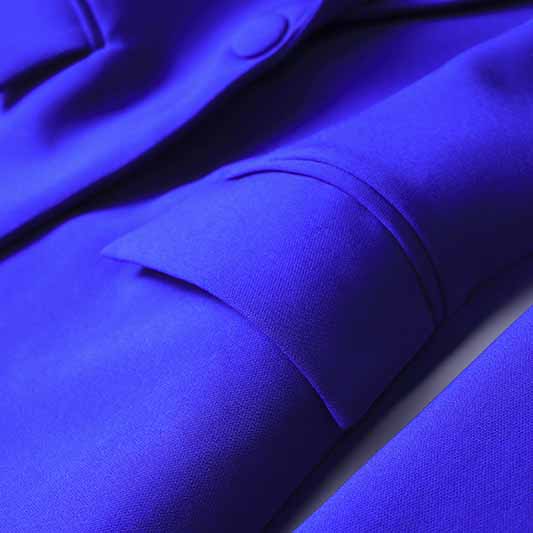 Close-up of sd-hk one button blazer and flare pants set in vibrant blue fabric showcasing sleek tailoring.