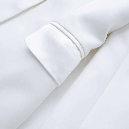 Close-up of a Tucomosi women's wedding suit with feathers featuring elegant satin fabric and detailed cuffs