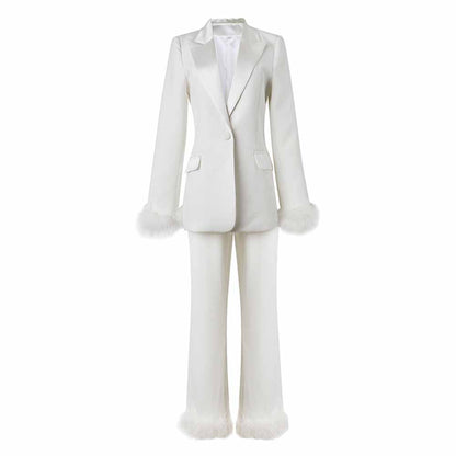 Elegant women's wedding suit with feathers featuring a tailored blazer and matching trousers