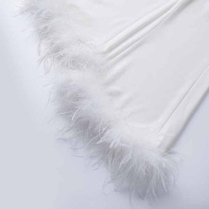 Elegant women's wedding suit with feathers detail along the edges for a stylish bridal look
