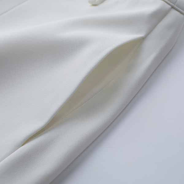 Close-up of Tucomosi women's wedding suit with feathers featuring elegant detailing and tailored design